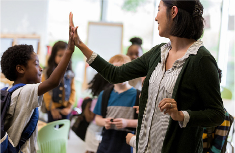 Teacher giving a student a high five.
