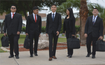 High school students dressed professionally holding suitcase bags High school students dressed professionally holding suitcase bags
