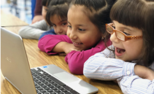 Students engaged watching a video on a laptop Students engaged watching a video on a laptop