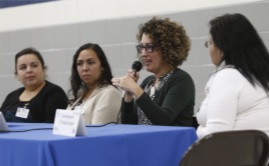 Four adults participating in a panel discussion