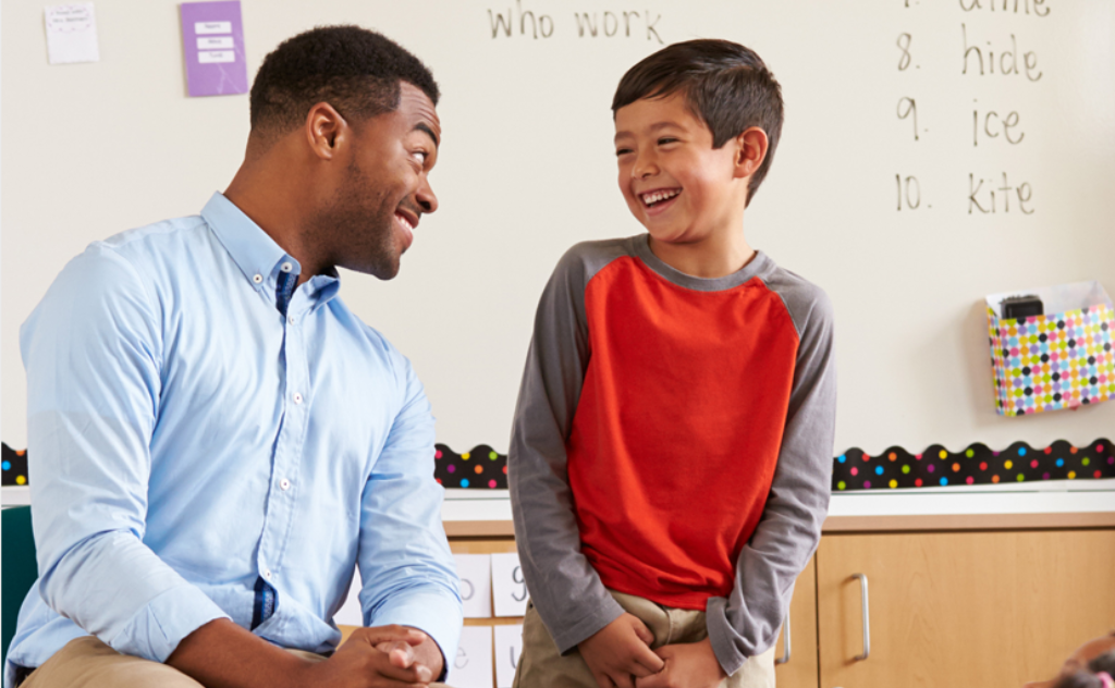 Teacher and student laughing