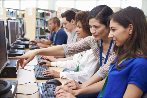 Teacher guiding a student in computer lab